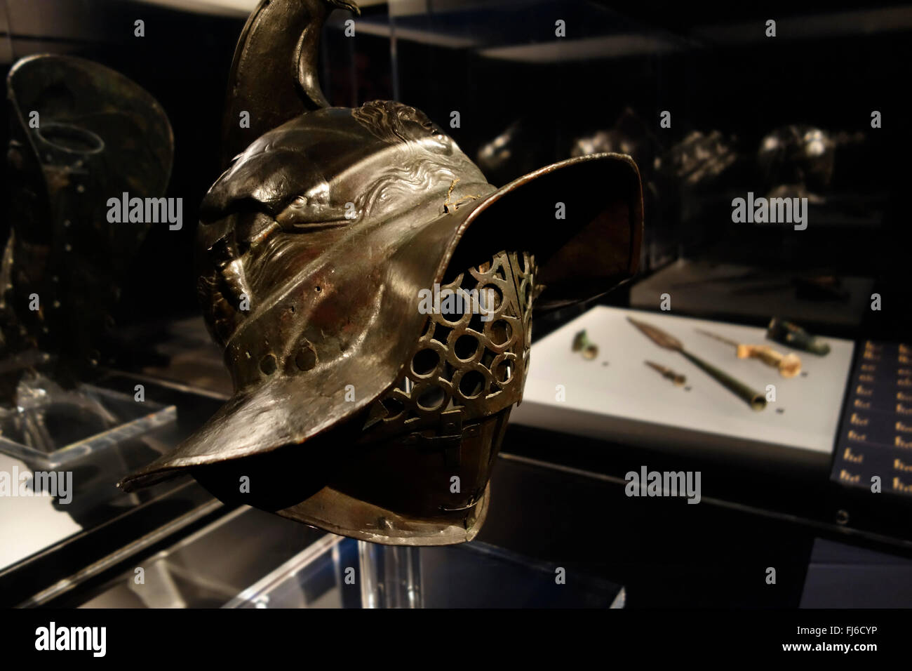Thracian gladiator helmet and weapons on display in the Gallo-Romeins / Gallo Roman Museum, Tongeren, Belgium Stock Photo