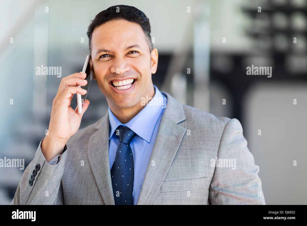 cheerful middle aged businessman talking on mobile phone Stock Photo