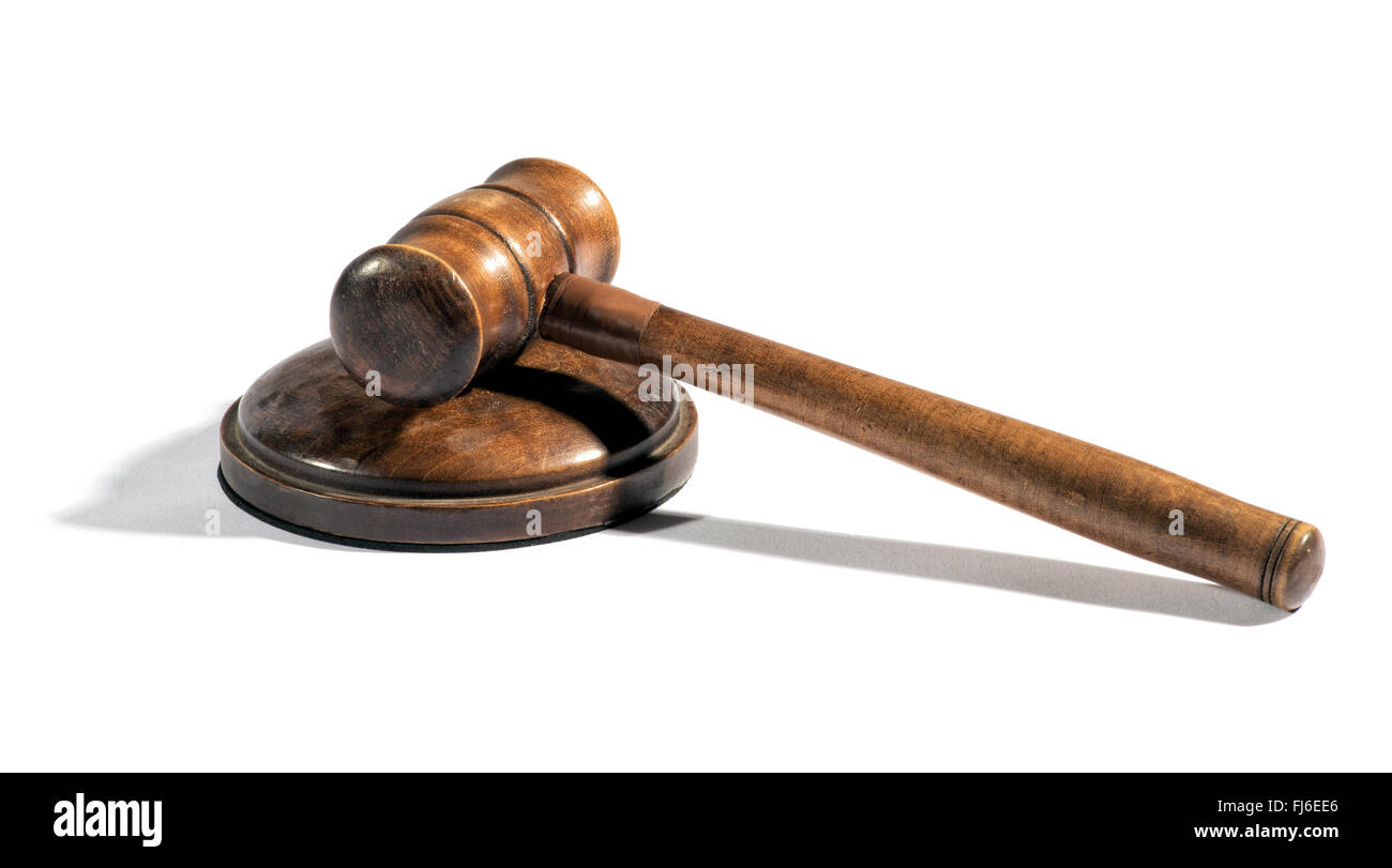 Old wooden judges gavel lying on a plinth over white with a shadow conceptual of law enforcement, justice and sentencing Stock Photo