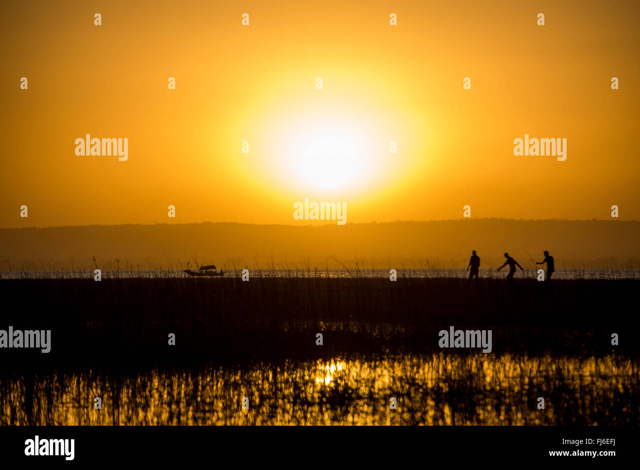Local people walking on pier at dusk Lake Ziway, Ethiopia, Africa Stock Photo