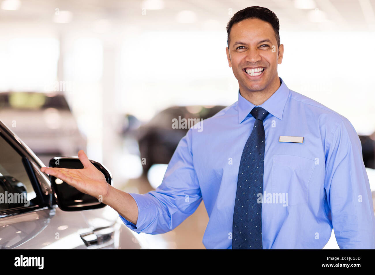 Good Looking Mid Age Car Salesman Presenting New Cars Stock Photo Alamy