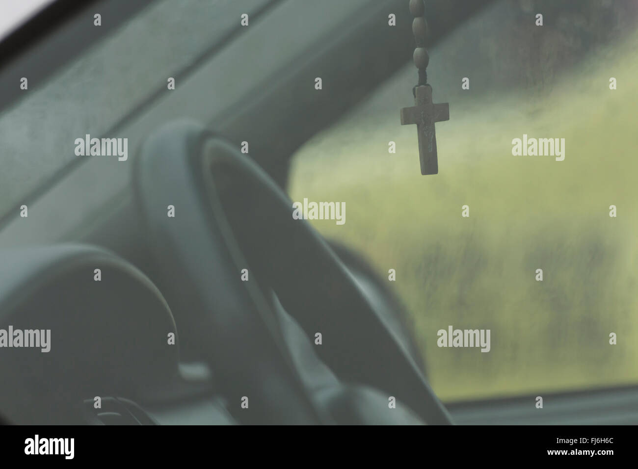 Cross hanging from the rear view mirror Stock Photo Alamy