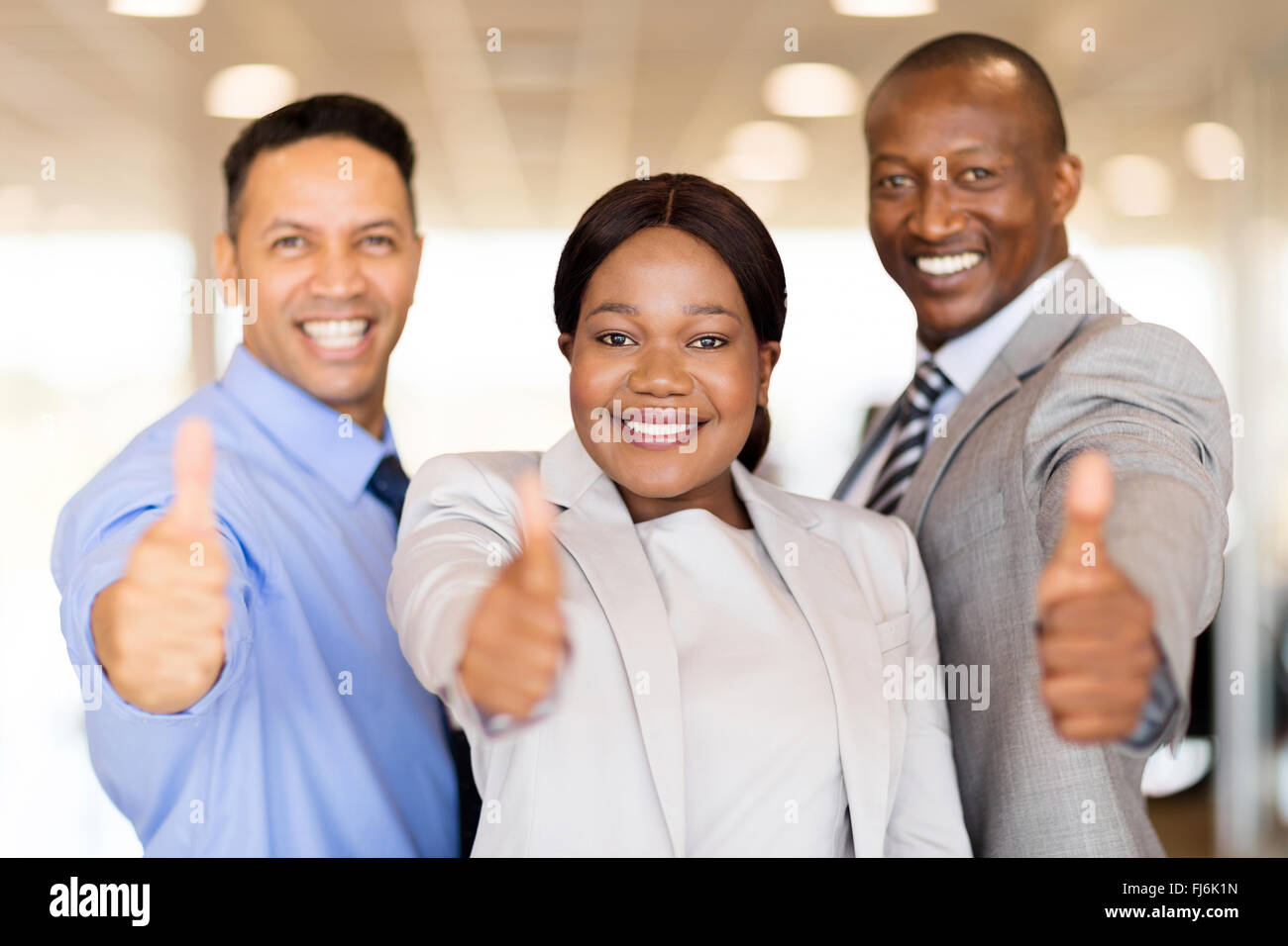 portrait of beautiful car dealership staff giving thumbs up Stock Photo