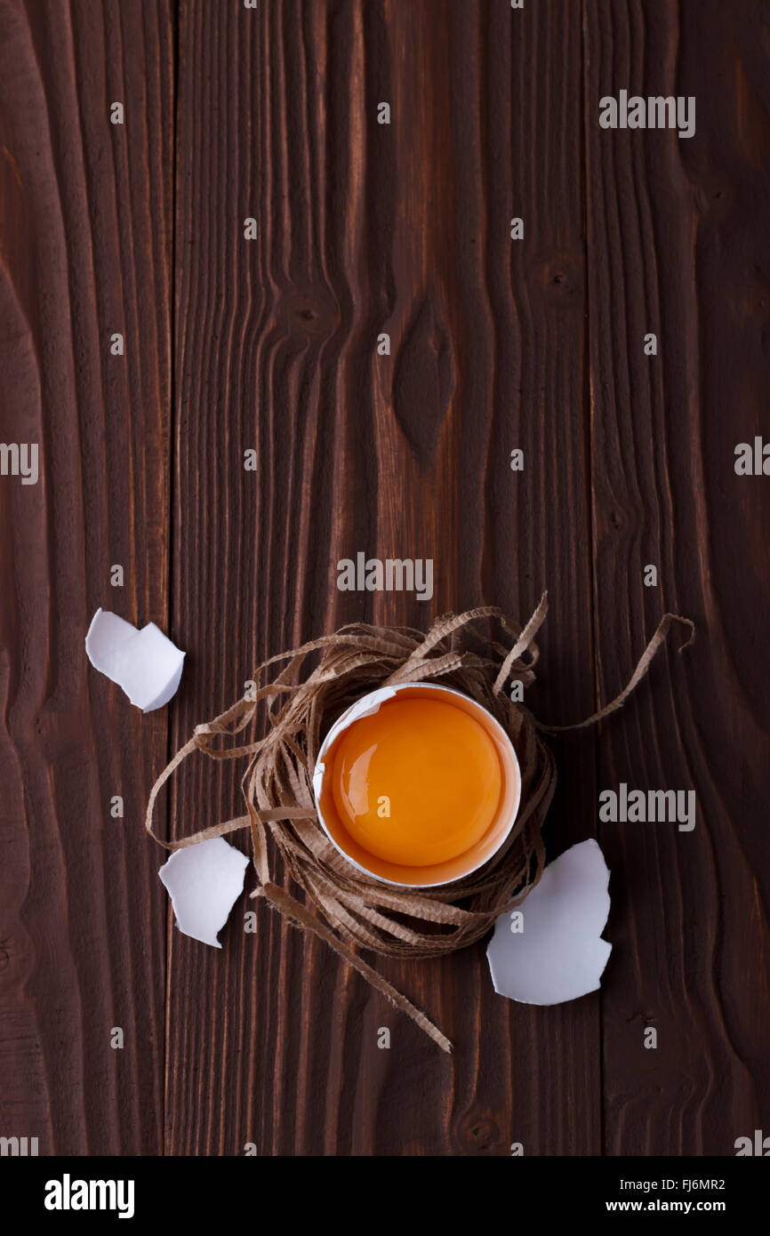 Closeup of an broken egg on wooden background Stock Photo