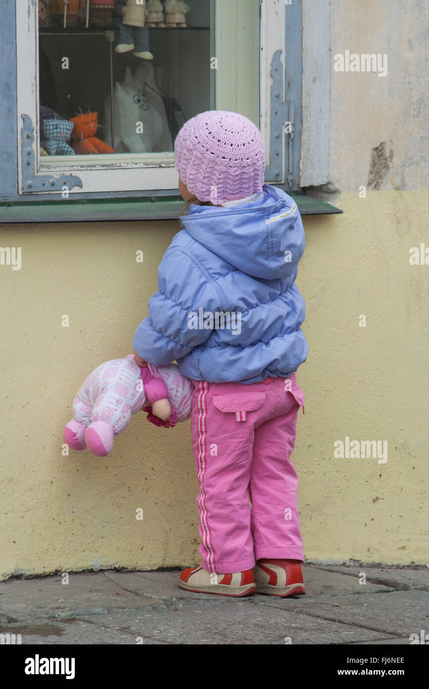 Toddler window shopping in the old town, Tallinn, Estonia Stock Photo