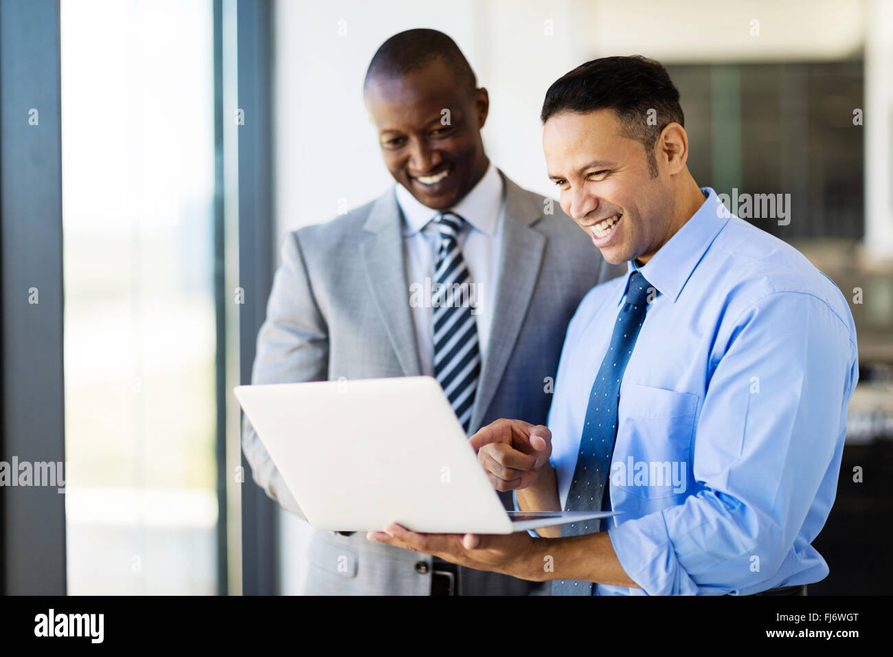 two businessman using laptop in modern office Stock Photo