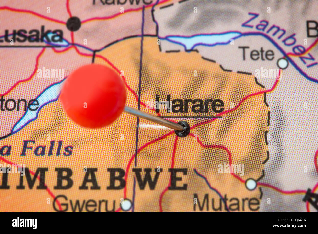 Close-up of a red pushpin in a map of Harare, Zimbabwe. Stock Photo