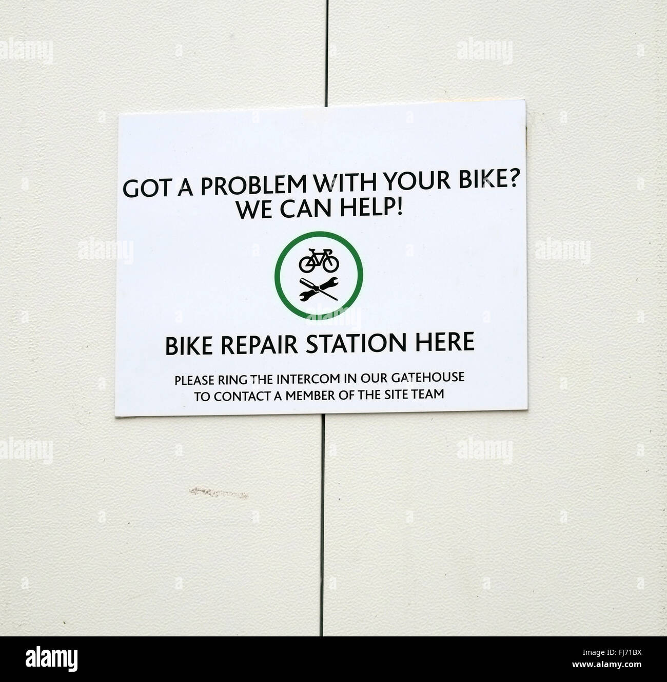 Bike repair station sign on the wall around a construction site in