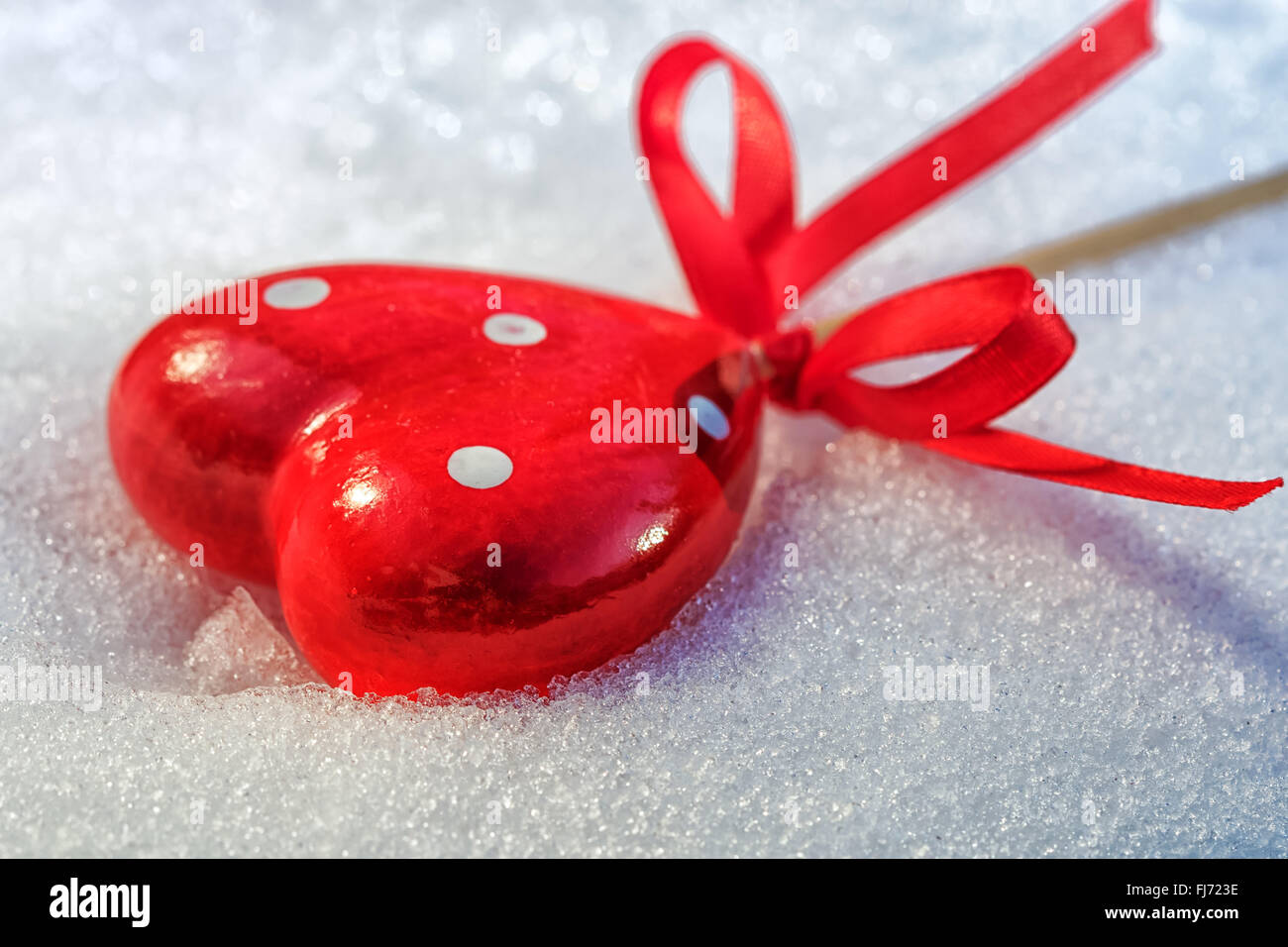 Red Heart on Ice Wet Snow Melts, selective focus, outdoors image Stock Photo