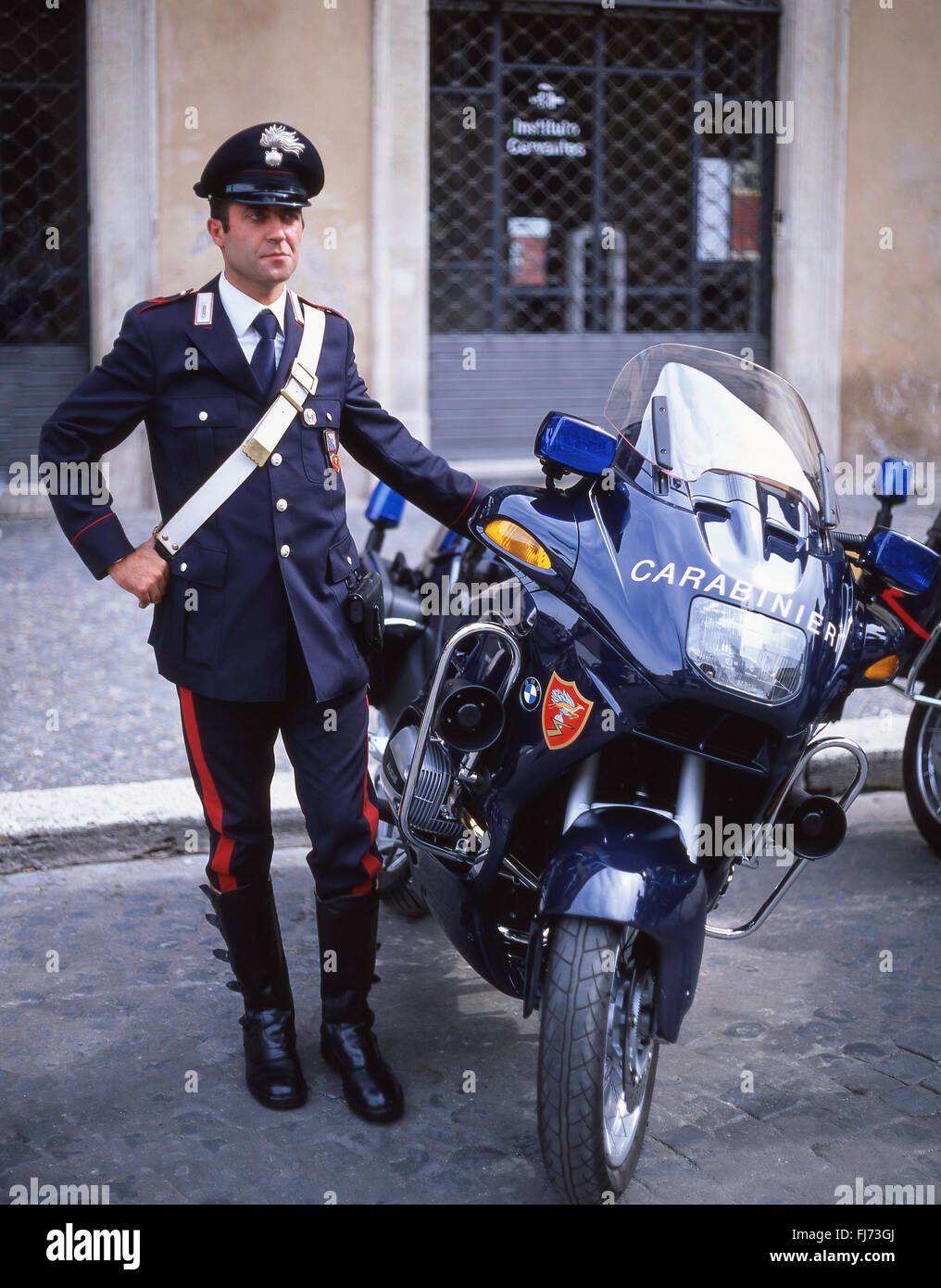 Italian policeman (Carabinieri) standing by motorbike, Rome (Roma), Lazio Region, Italy Stock Photo