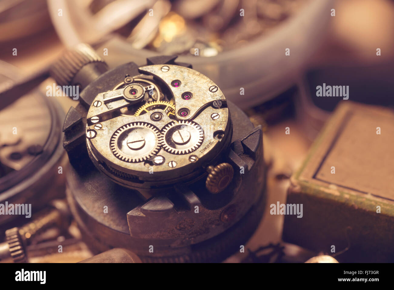 Old Watchmaker Studio. A watch makers work top. The inside workings of a vintage mechanical watch. Stock Photo