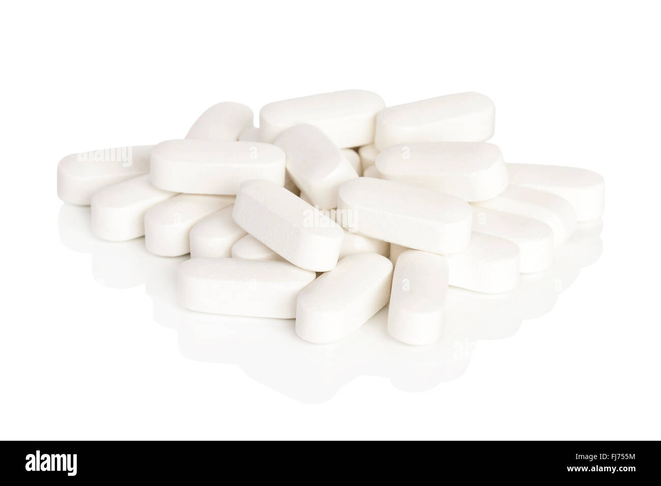 A pile of calcium vitamin supplement tablets isolated on a white background. Stock Photo