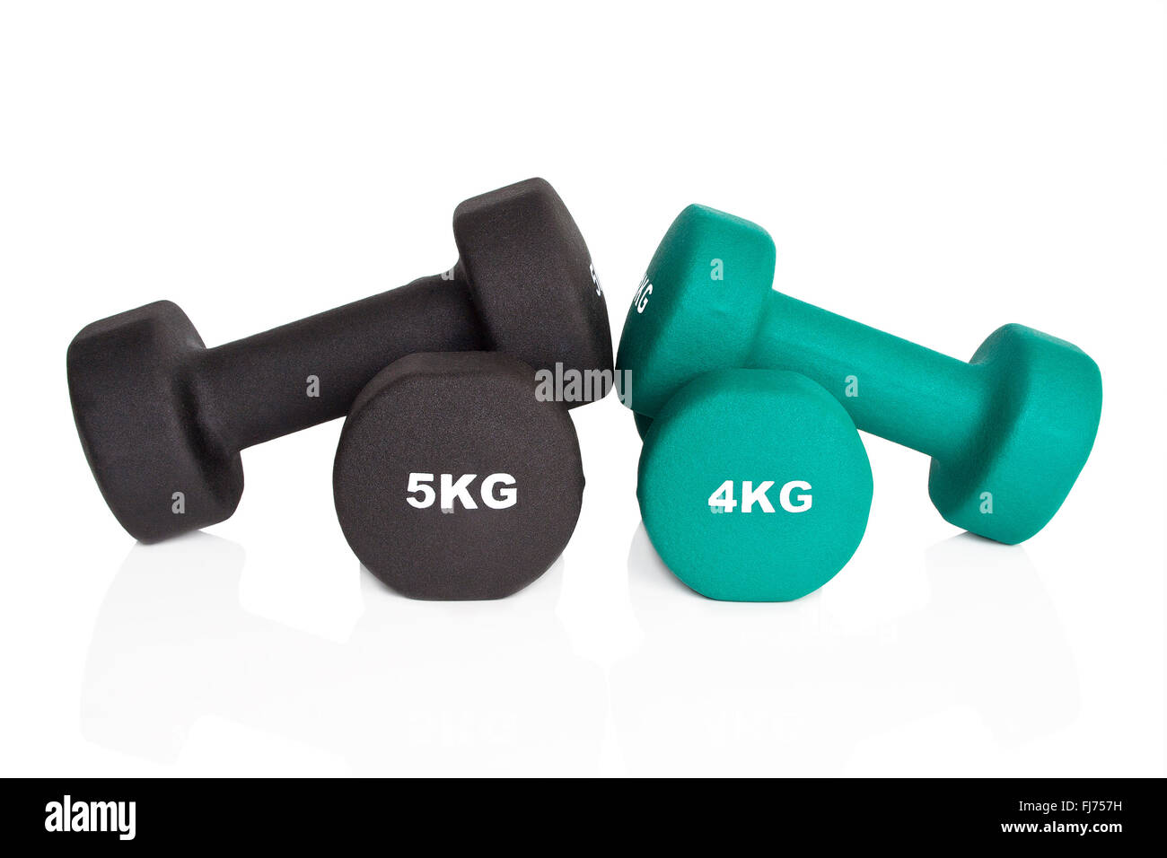 Green 4kg and black 5kg dumbbells isolated on white background. Weights for a fitness training. Stock Photo
