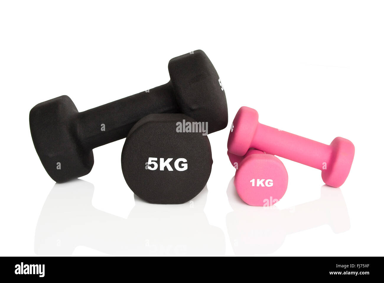 Pink 1kg and black 5kg dumbbells isolated on white background. Weights for a fitness training. Stock Photo