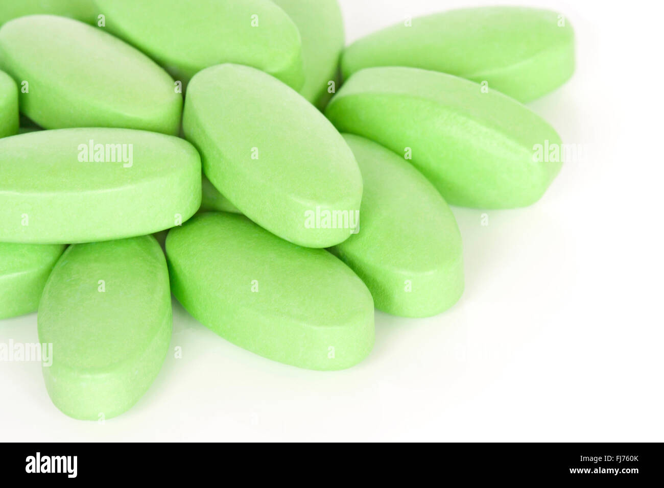 A pile of vitamin B supplement tablets isolated on a white background. Stock Photo