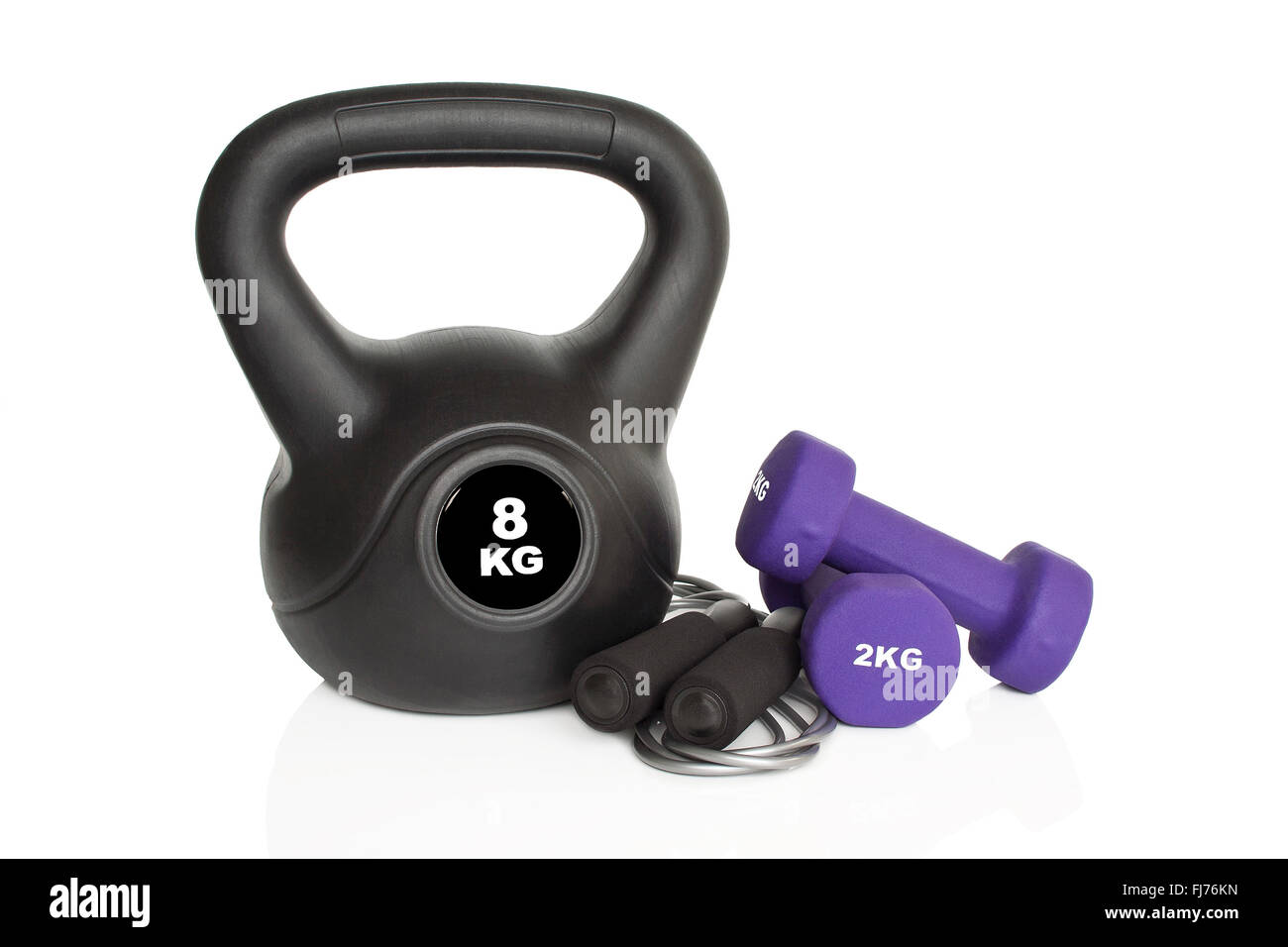 Dumbbells, kettlebell and skipping rope isolated on white background. Weights for a fitness training. Stock Photo