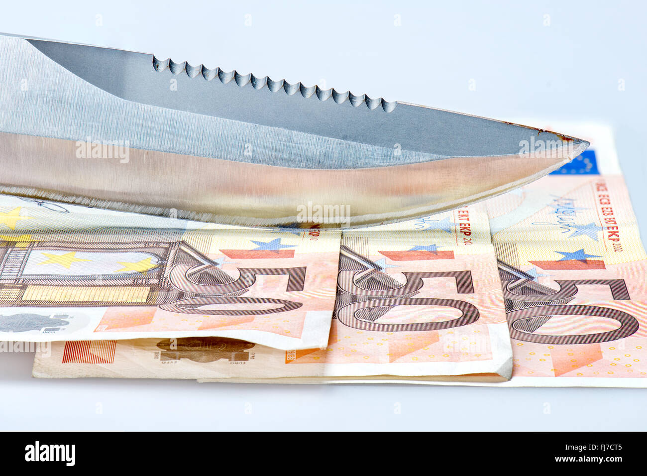 Knife with euro money note Stock Photo