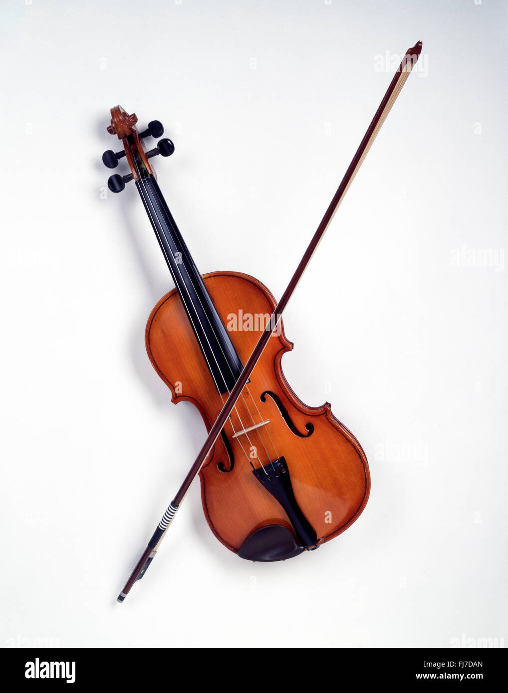 Still-life of violin with bow on white background, London, England, United Kingdom Stock Photo