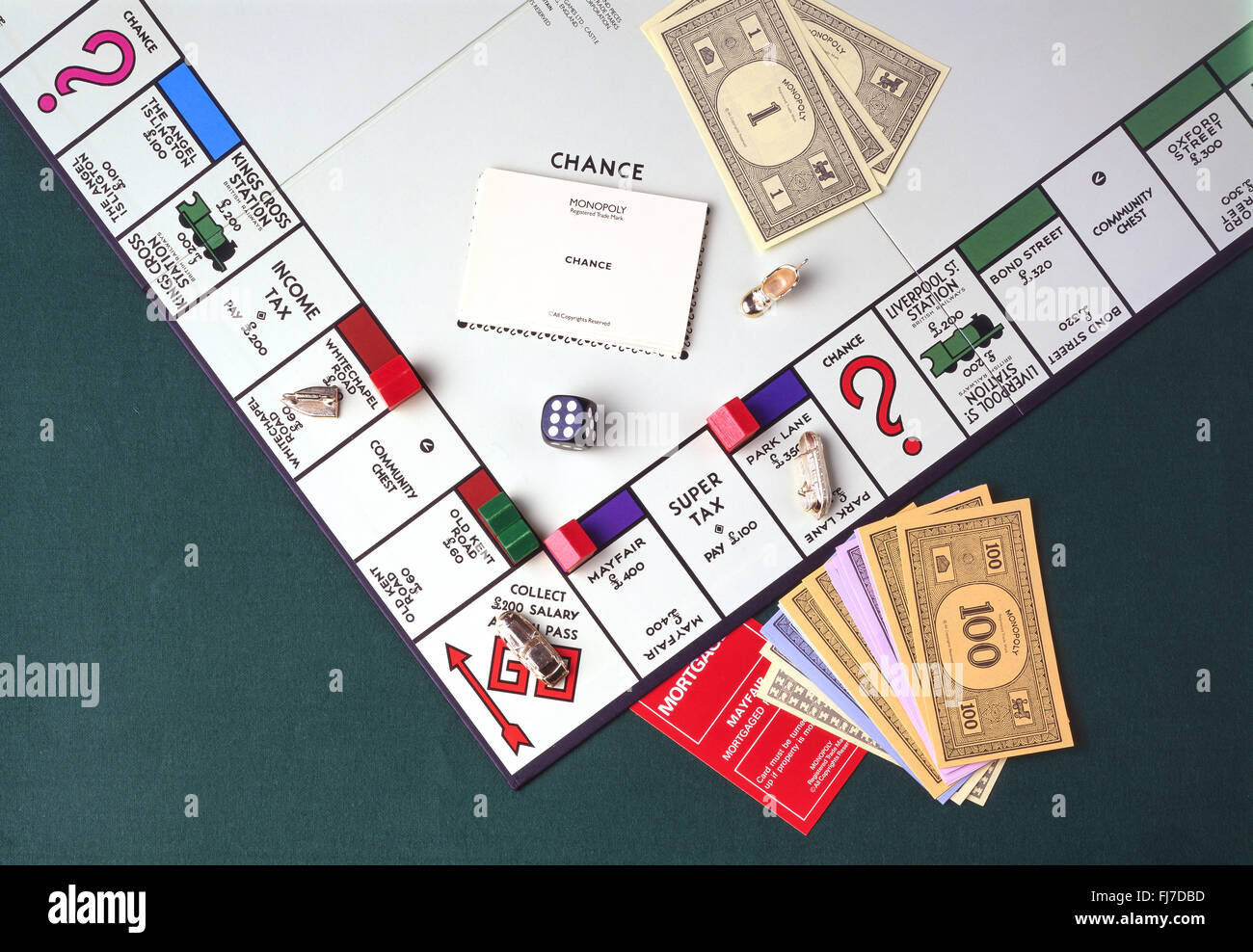 Monopoly board game with money, notes, counters and dice in studio setting, Greayer London, England, United Kingdom Stock Photo