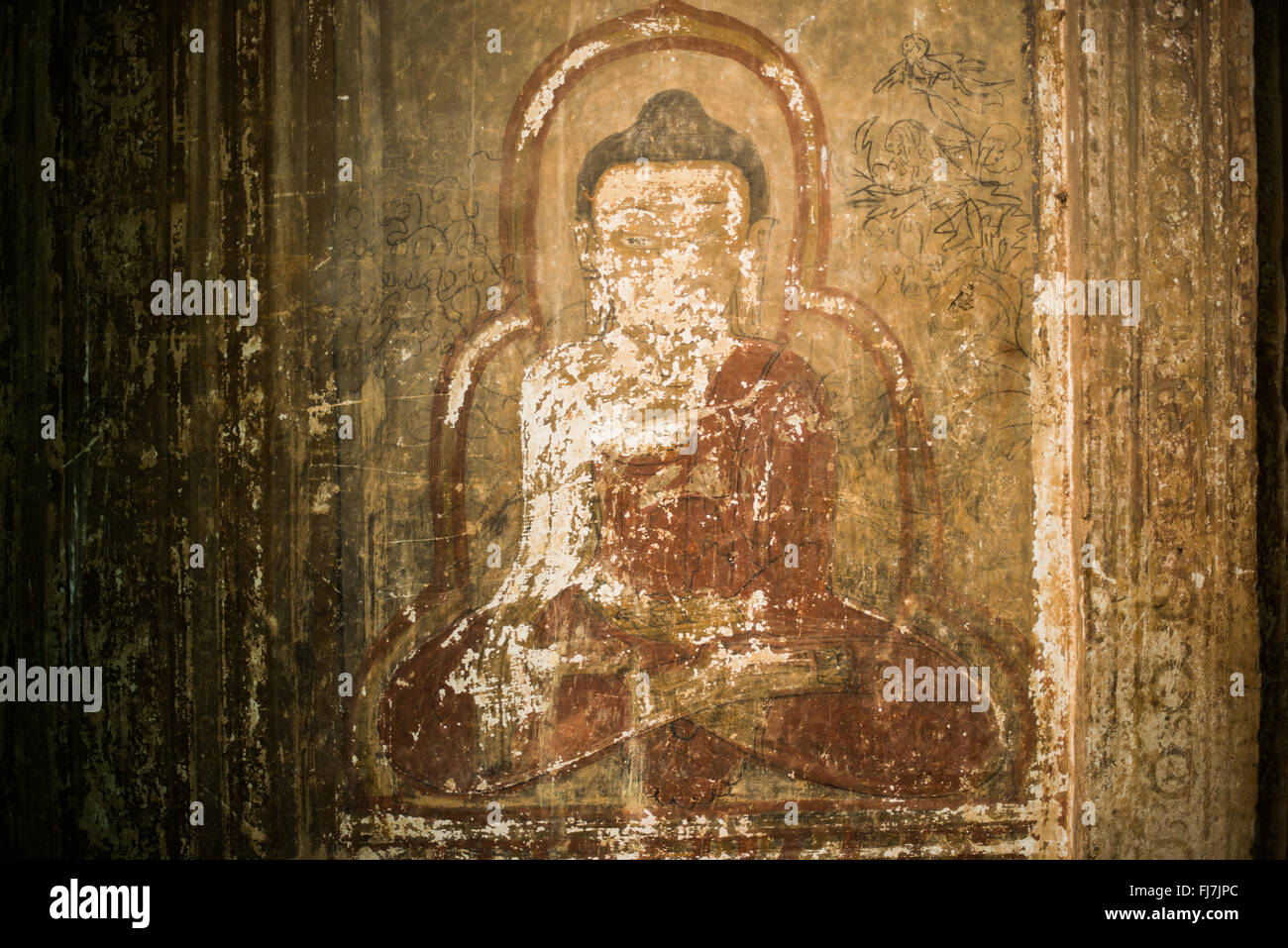 A painting of Gautama Buddha on a wall inside Htilominlo Temple, near Nyaung-U, named after the king of Pagan dynasty of Burma (Myanmar) from 1211 to 1235. His 24-year reign marked the beginning of the gradual decline of Pagan dynasty. Stock Photo
