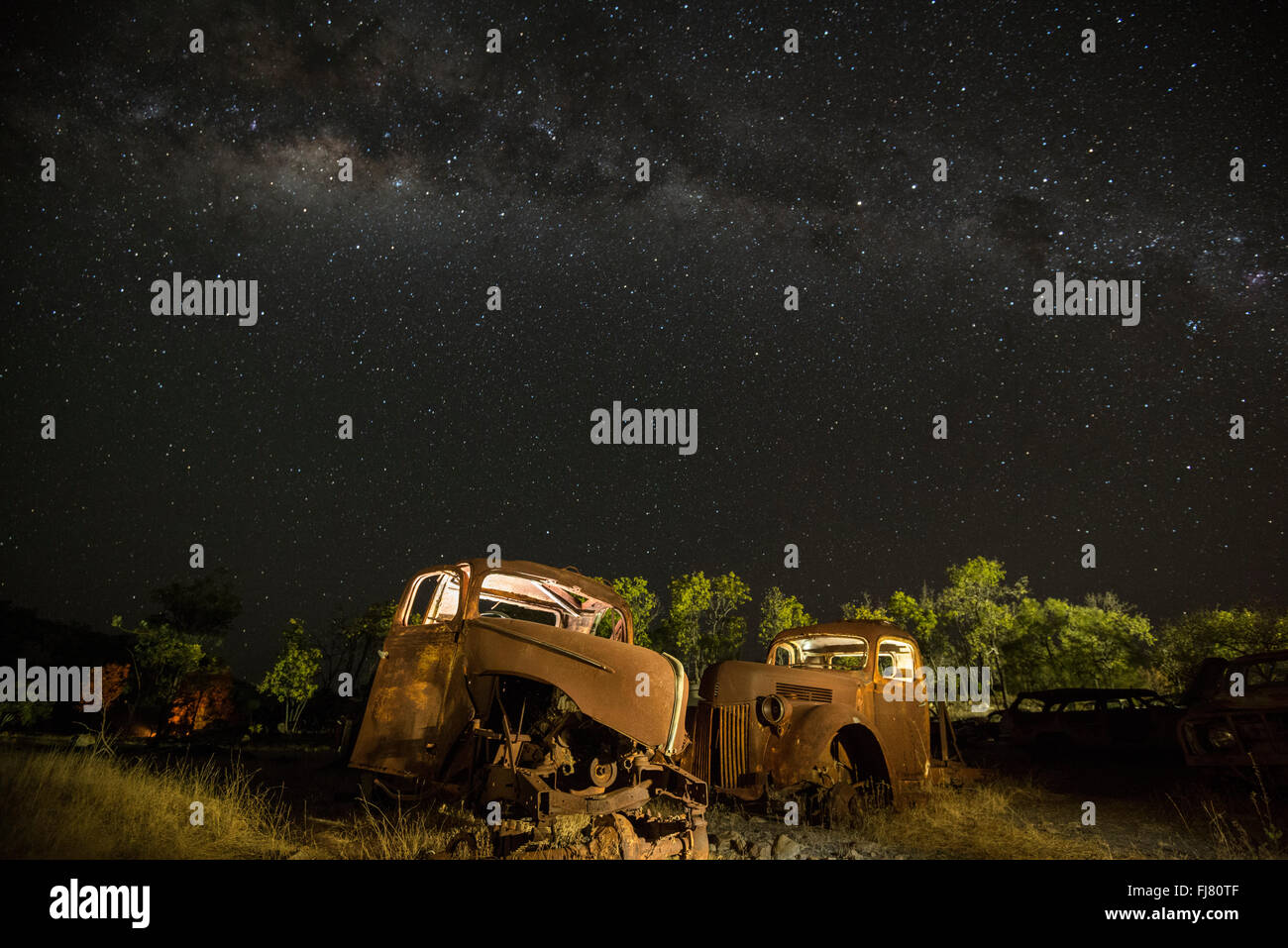 Milky Way over old decommissioned Ford cars in a collector's backyard in outback Chillagoe. Stock Photo