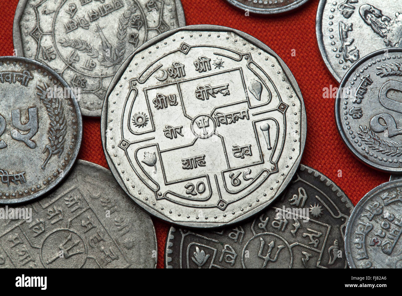 Coins of Nepal. Hindu trishul depicted in the Nepalese rupee coins ...