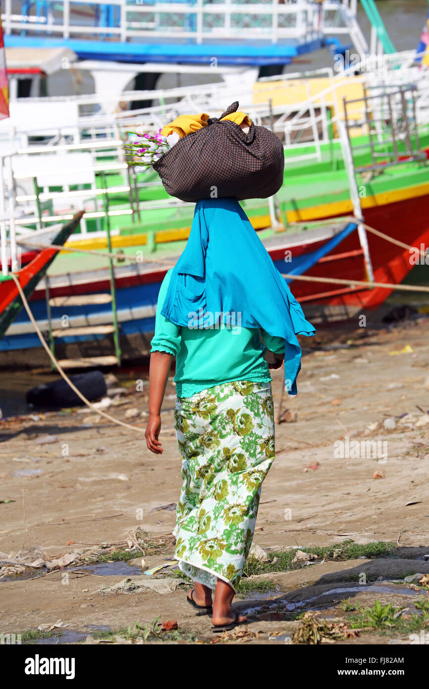 Woman carrying bag on her head in Old Bagan, Bagan, Myanmar (Burma