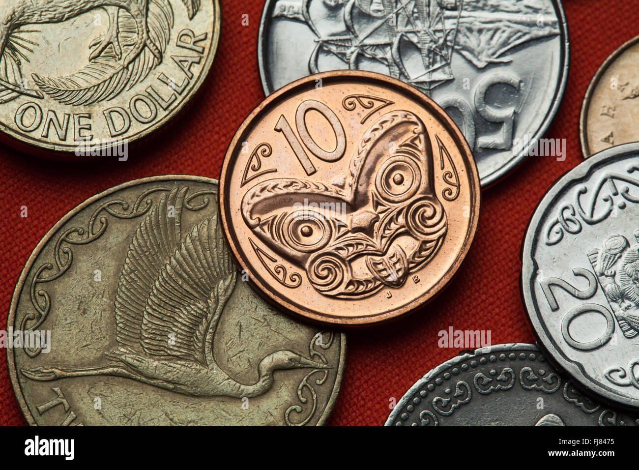Coins of New Zealand. Maori carved head called koruru depicted in the New Zealand 10 cents coin. Stock Photo