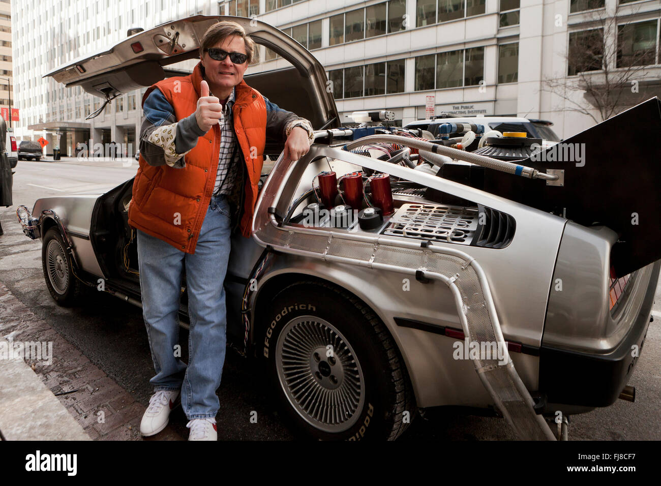 Back to the Future Marty McFly impersonator posing next to DeLorean time machine - Washington, DC USA Stock Photo