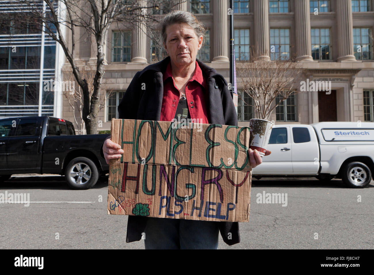 Homeless woman holding sign - Washington, DC USA Stock Photo