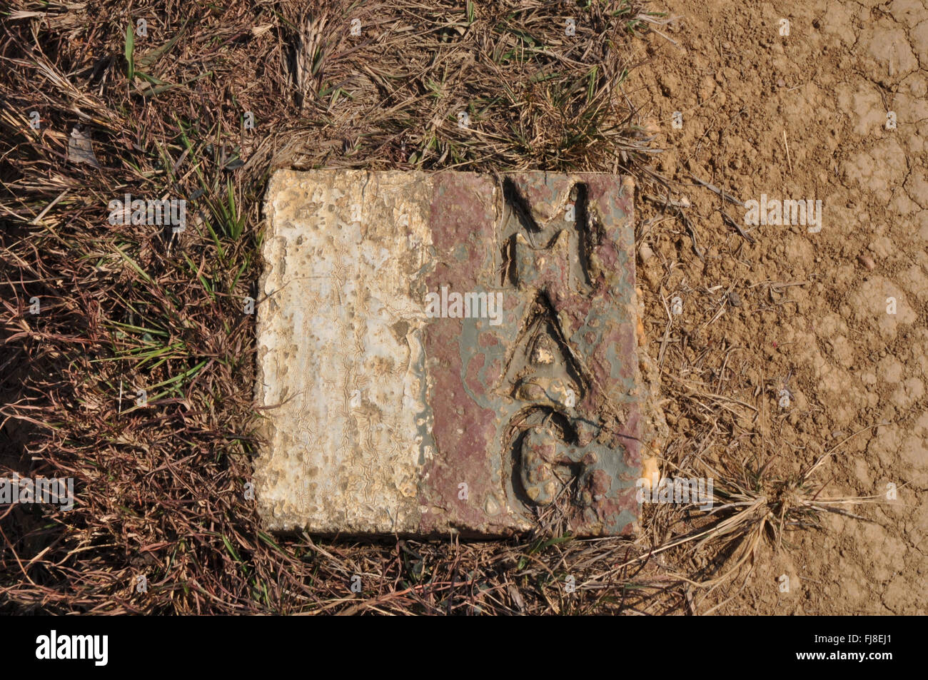 Marker MAG indicating the areas that have been cleared of unexploded ordnance (UXO). Plain of Jars, Xieng Khuang Province, Laos Stock Photo