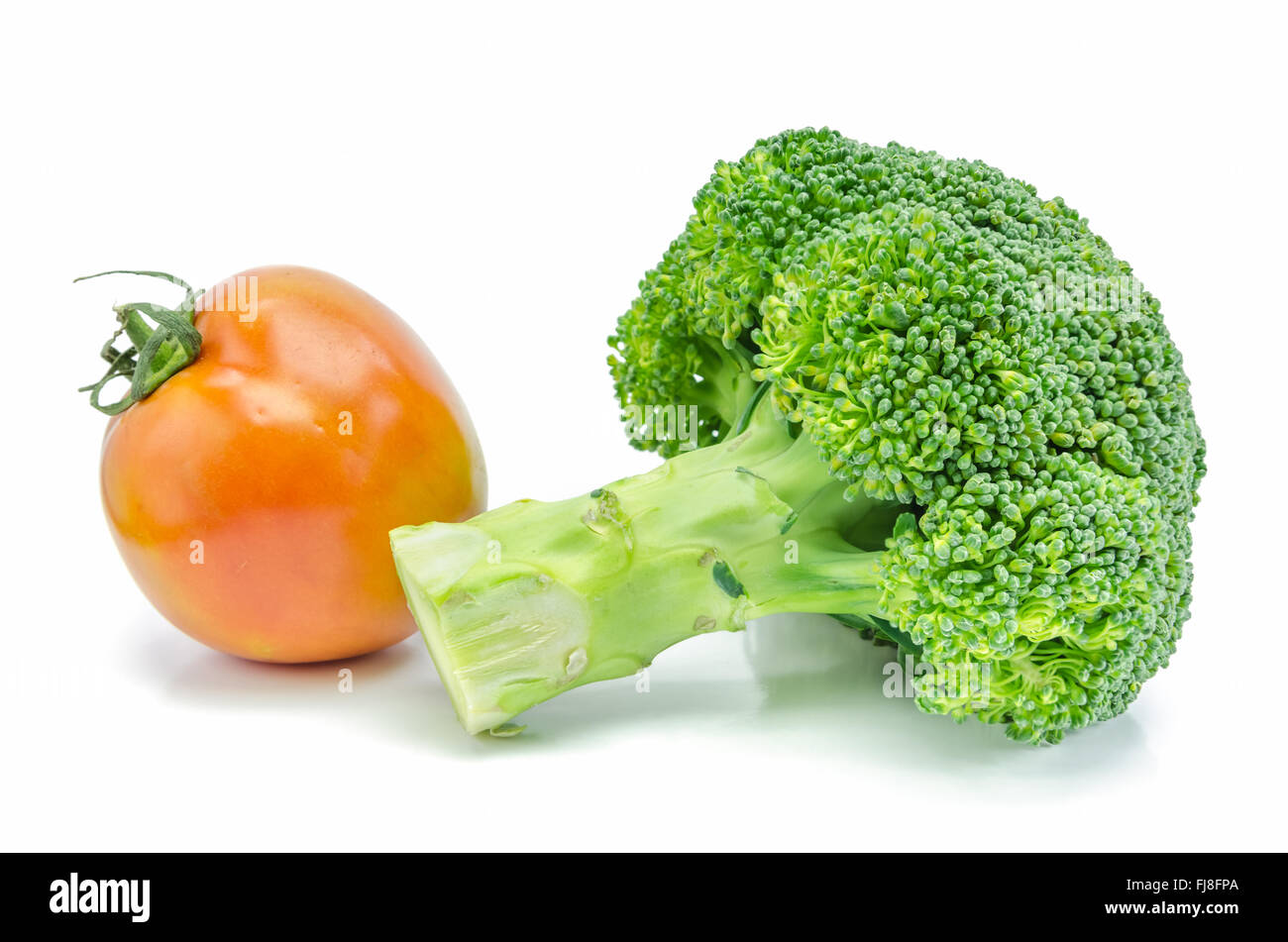 Fresh raw broccoli and tomato vegetable on white background. Stock Photo