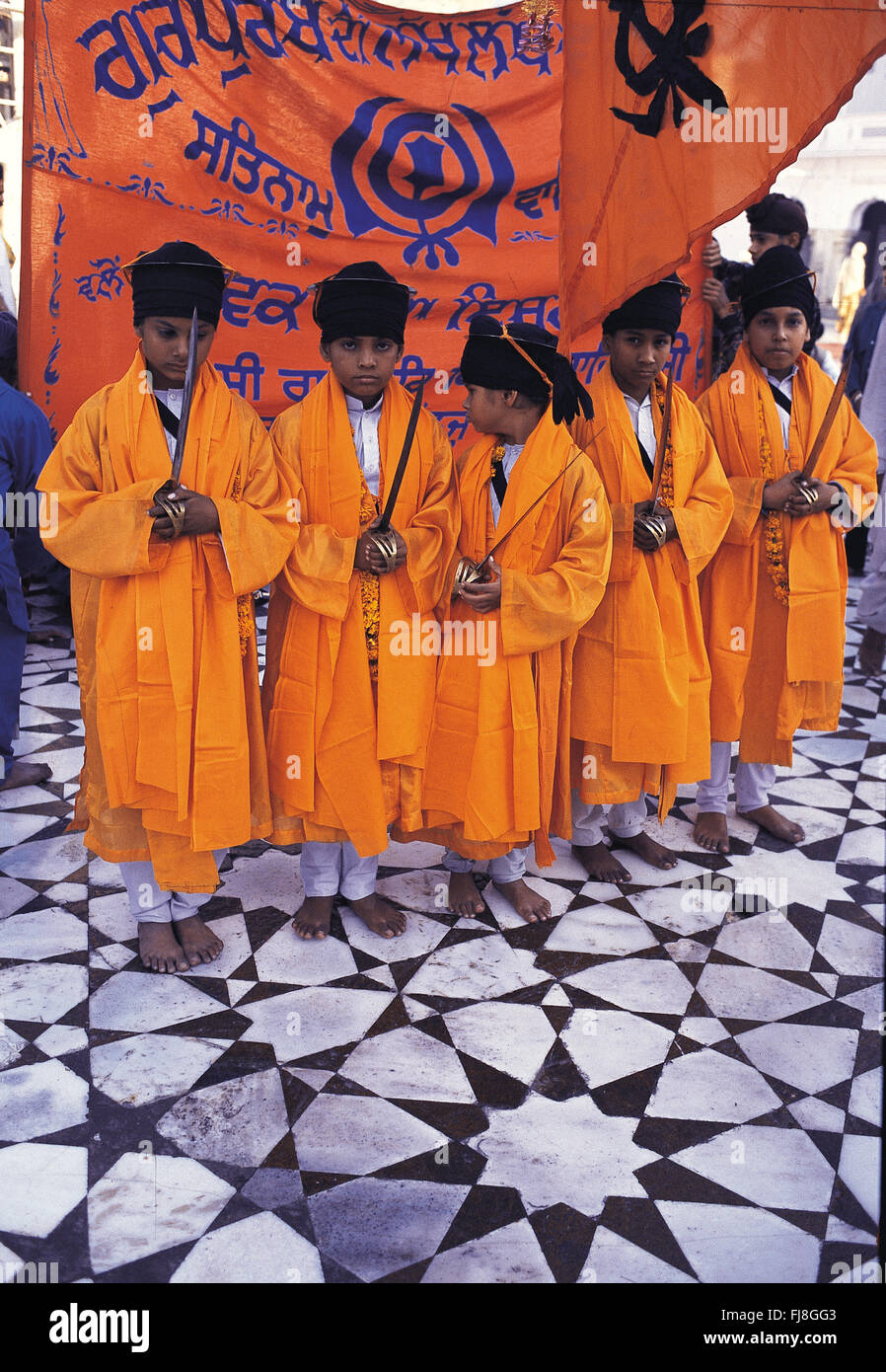 Children in saffron robes, golden temple, amritsar, punjab, india, asia Stock Photo