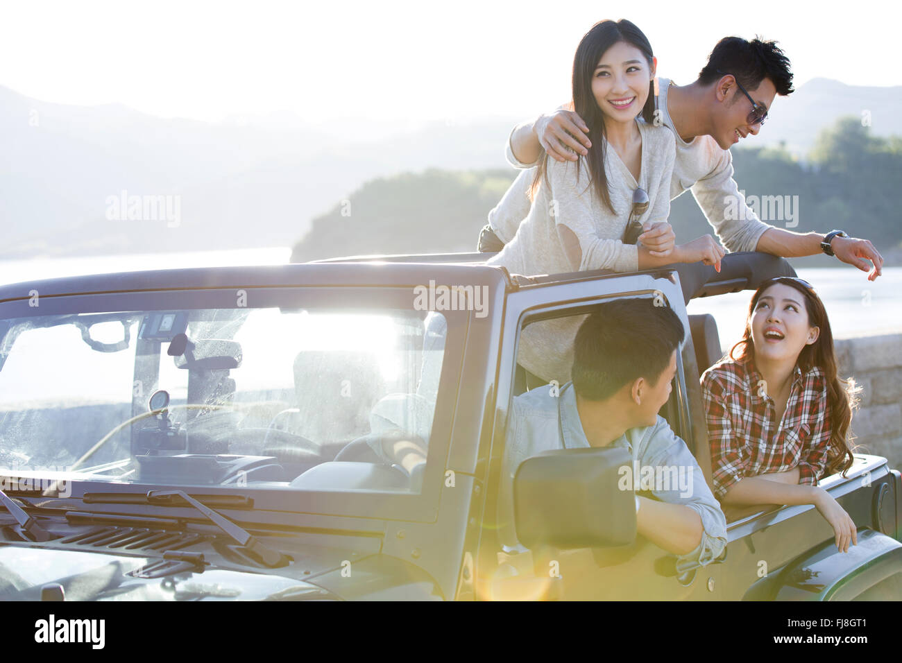 Chinese friends having fun in a jeep Stock Photo