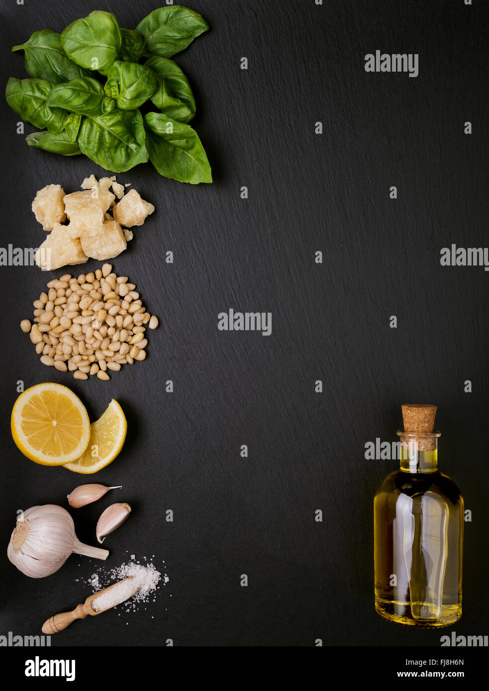 Ingredients for pesto sauce preparing on black slate background Stock Photo