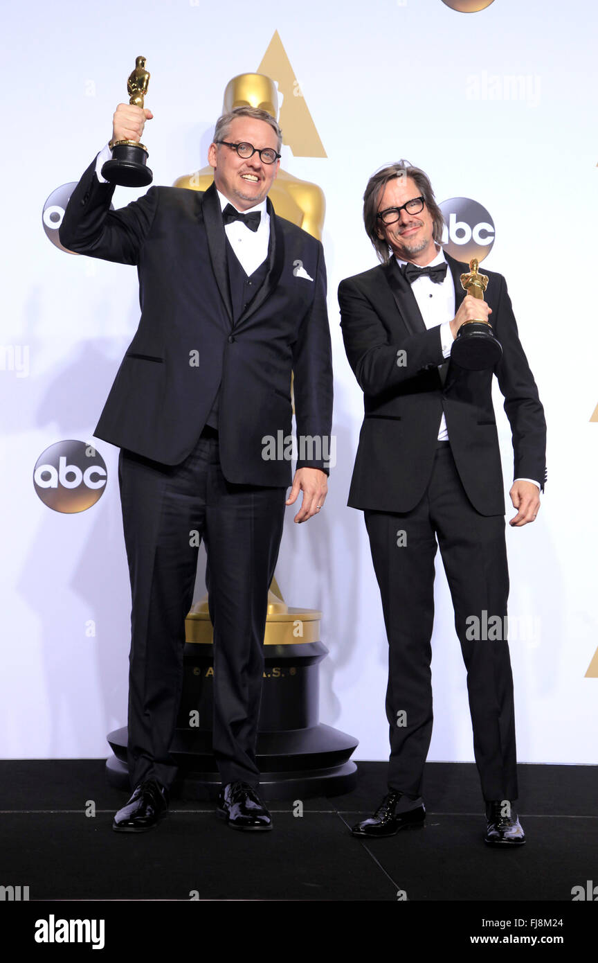 Writers Adam McKay (L) and Charles Randolph, winners of the Best Writing (Adapted Screenplay) award for 'The Big Short', pose in the press room during the 88th Annual Academy Awards at Loews Hollywood Hotel on February 28, 2016 in Hollywood, California. Stock Photo
