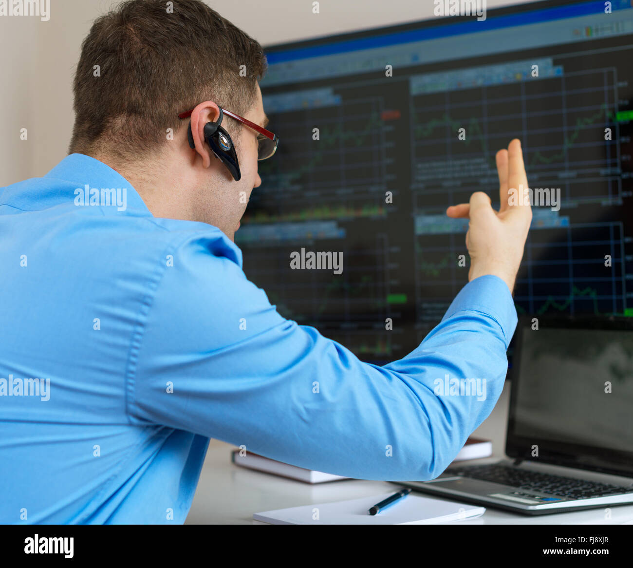Upset stock trader in front of computer. Stock Photo