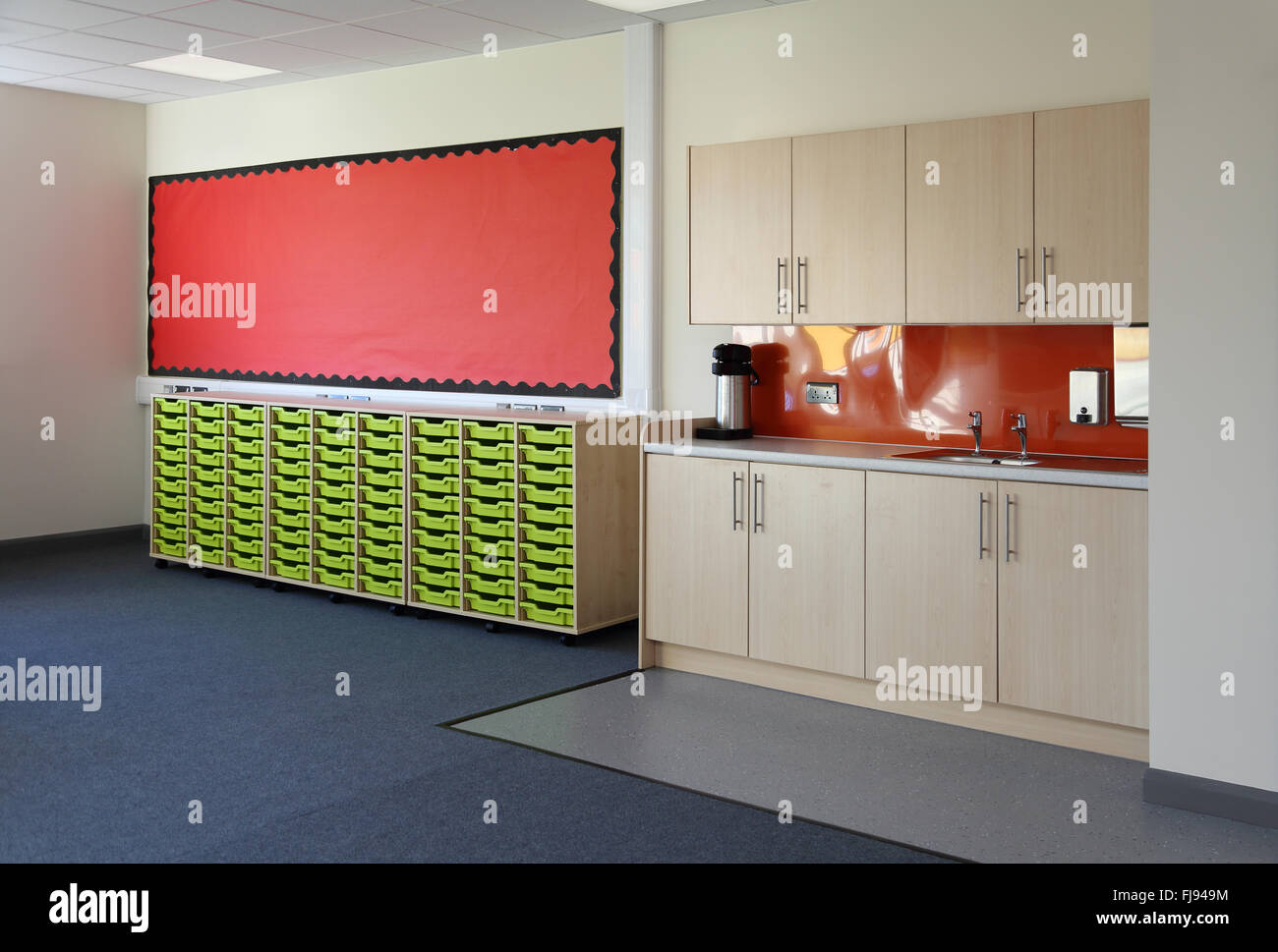 Wet area in a new school classroom. Shows sink and kitchen-style storage plus storage drawers for pupils Stock Photo