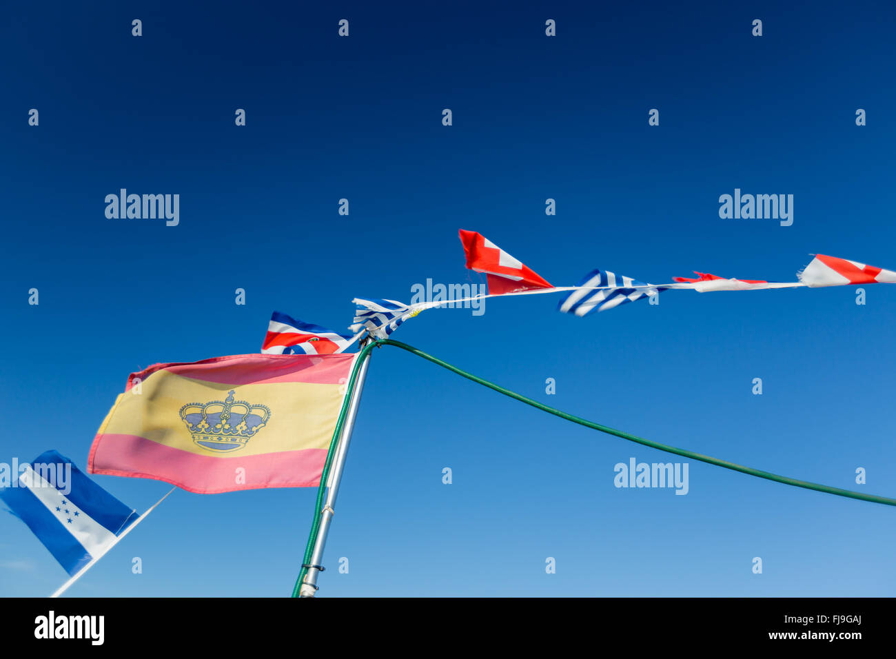 Some national flags fluttering against the blue sky Stock Photo - Alamy
