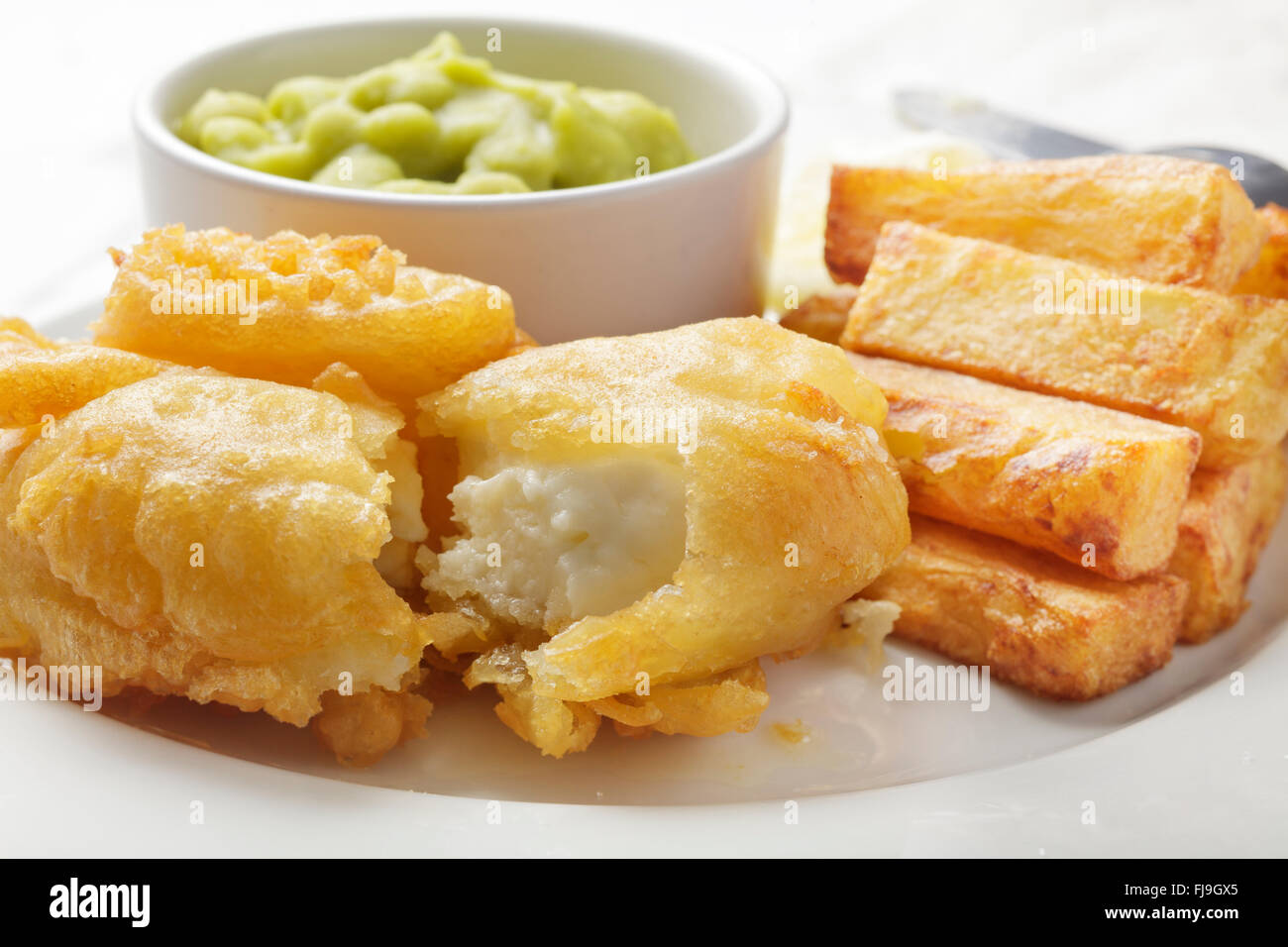 Halloumi battered with chips and mushy peas Stock Photo