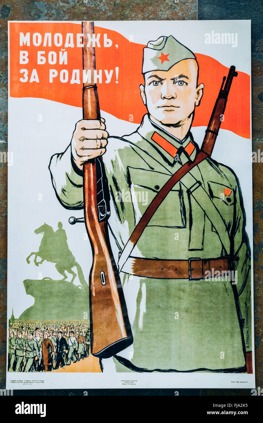 Soviet russian patriotic propaganda poster from World War II with image of soldier transferred rifle. Stock Photo