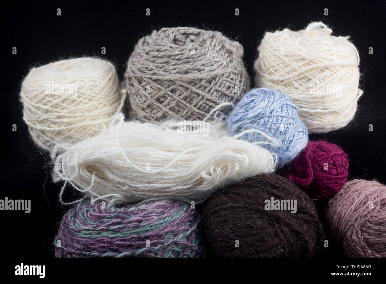 Balls of wool on a black background Stock Photo