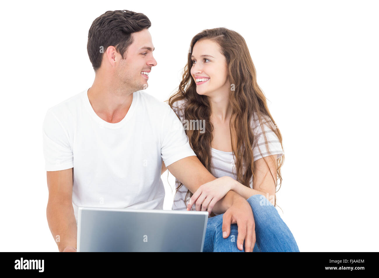 Young couple sitting on floor using laptop Stock Photo - Alamy