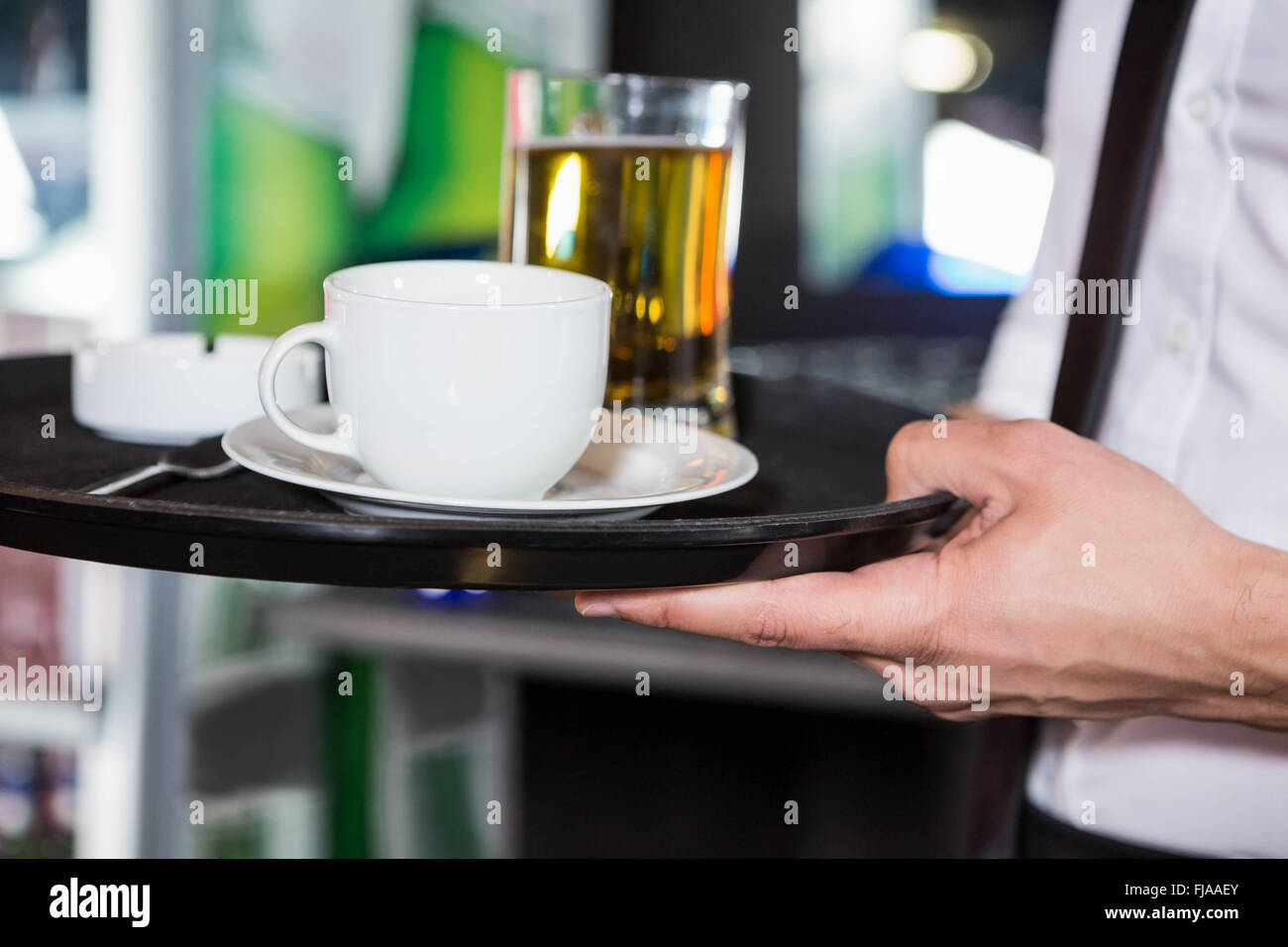 Waiter serving whiskey and a cup of coffee Stock Photo