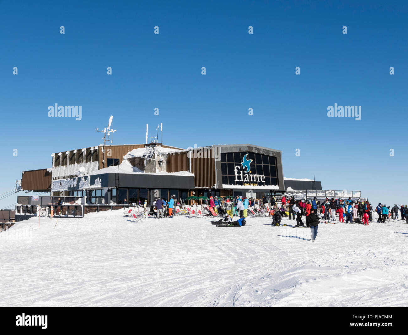 Les Grandes Platieres restaurant and gondola top station with skiers in Le Grand Massif ski area of French Alps. Flaine France Stock Photo