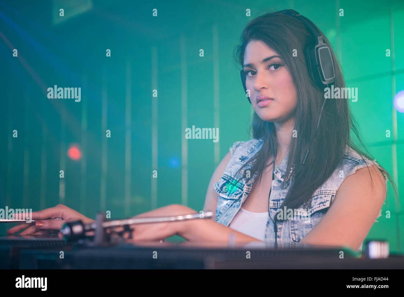Pretty female DJ playing music Stock Photo Alamy