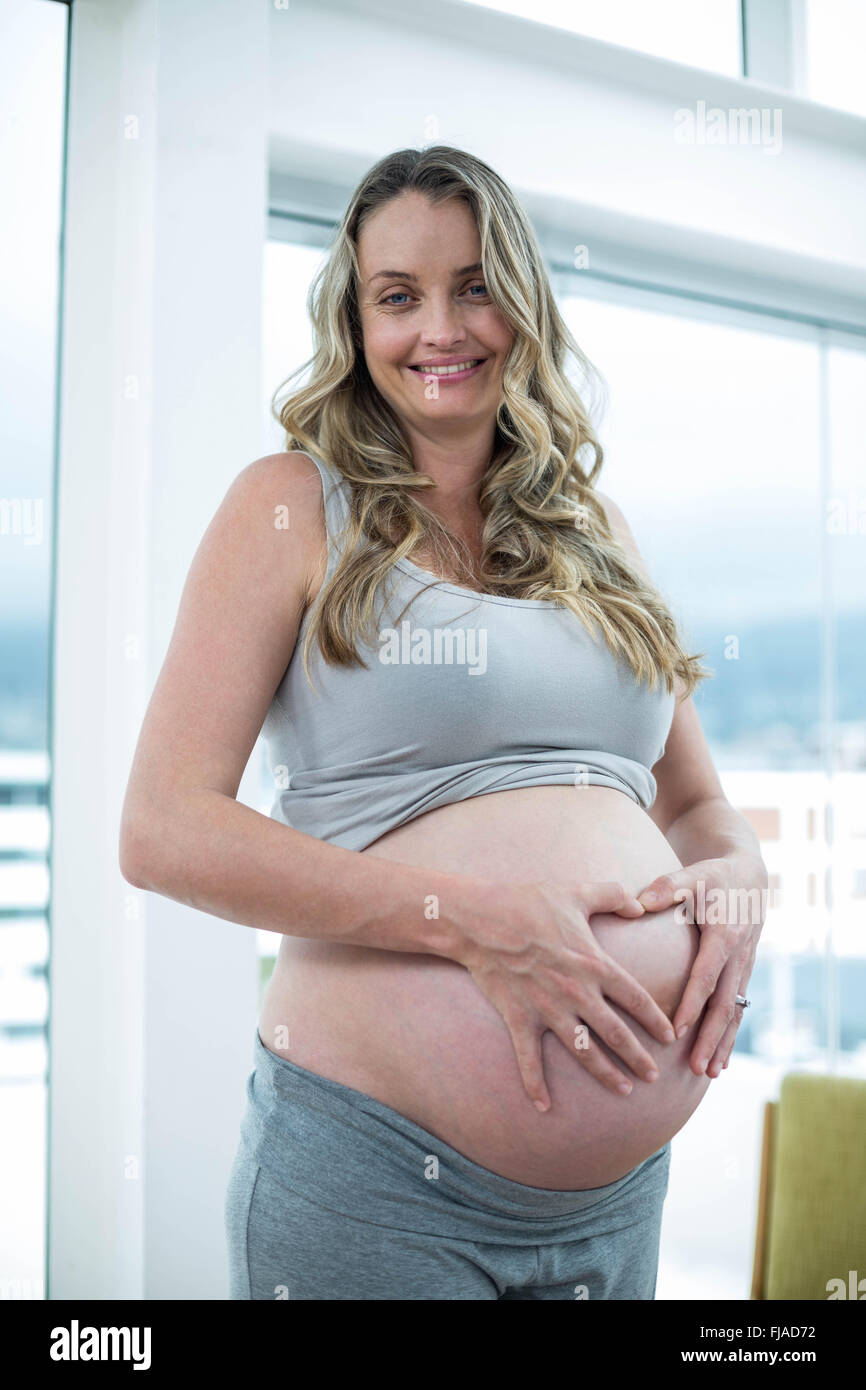 Pregnant woman holding her stomach Stock Photo