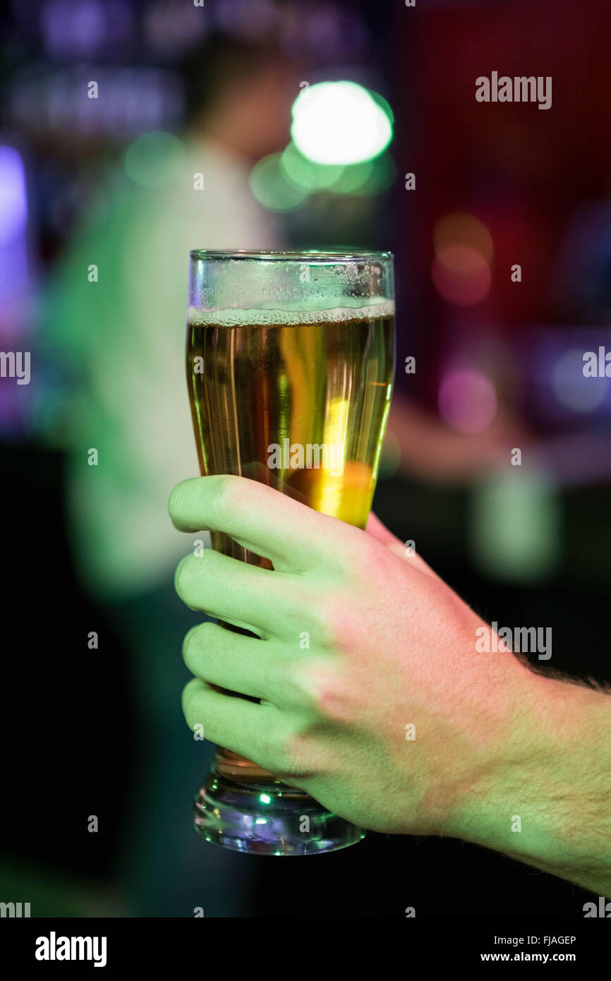 Close-up of man holding glass of beer Stock Photo