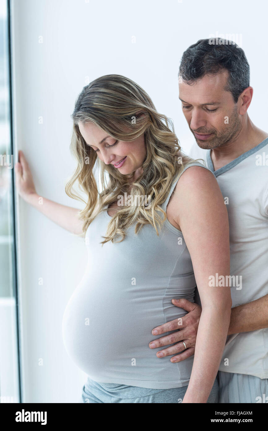 Man pregnant woman looking down stomach hi-res stock photography and images 