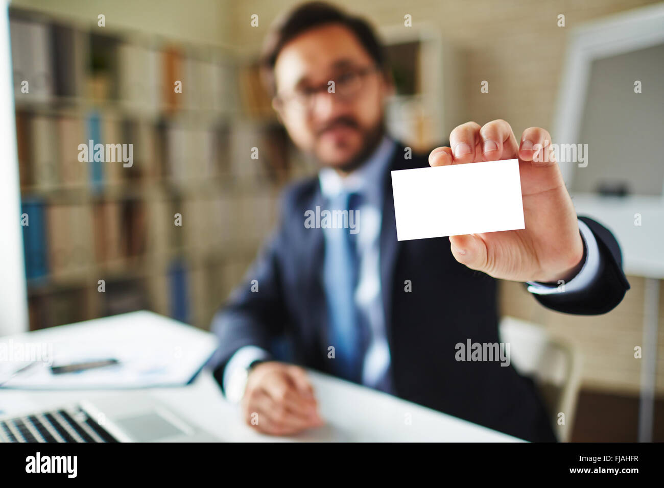 Close-up of businessman holding a blank card Stock Photo